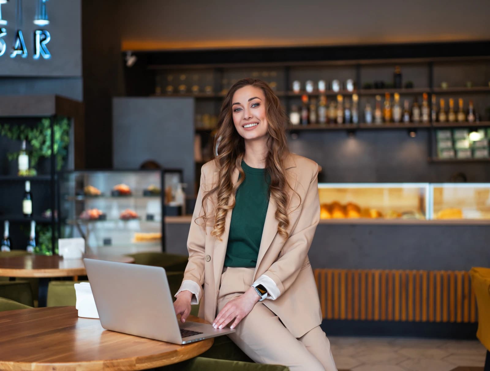 Professional businesswoman working on a laptop at a café